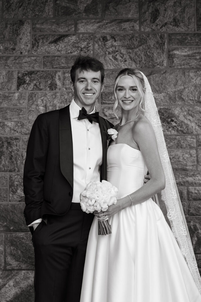 portrait of bride and groom hidden from the wind