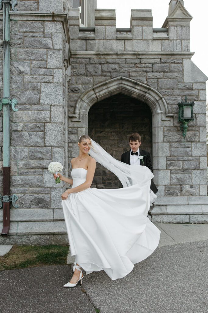 wind taking the brides dress as they walk back inside to see their family