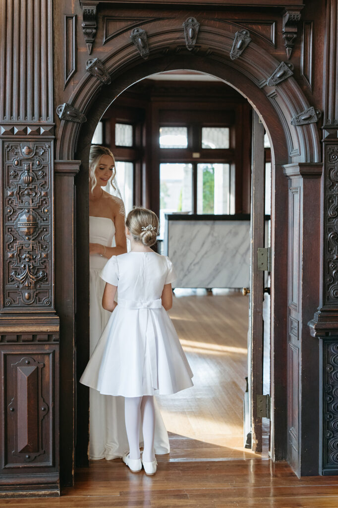 bride and flower girl having a moment together before the ceremony