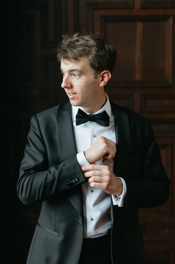 groom getting ready and fixing his cufflings