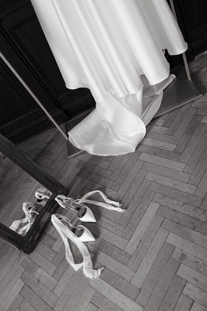 bottom of dress and shoes in front of mirror