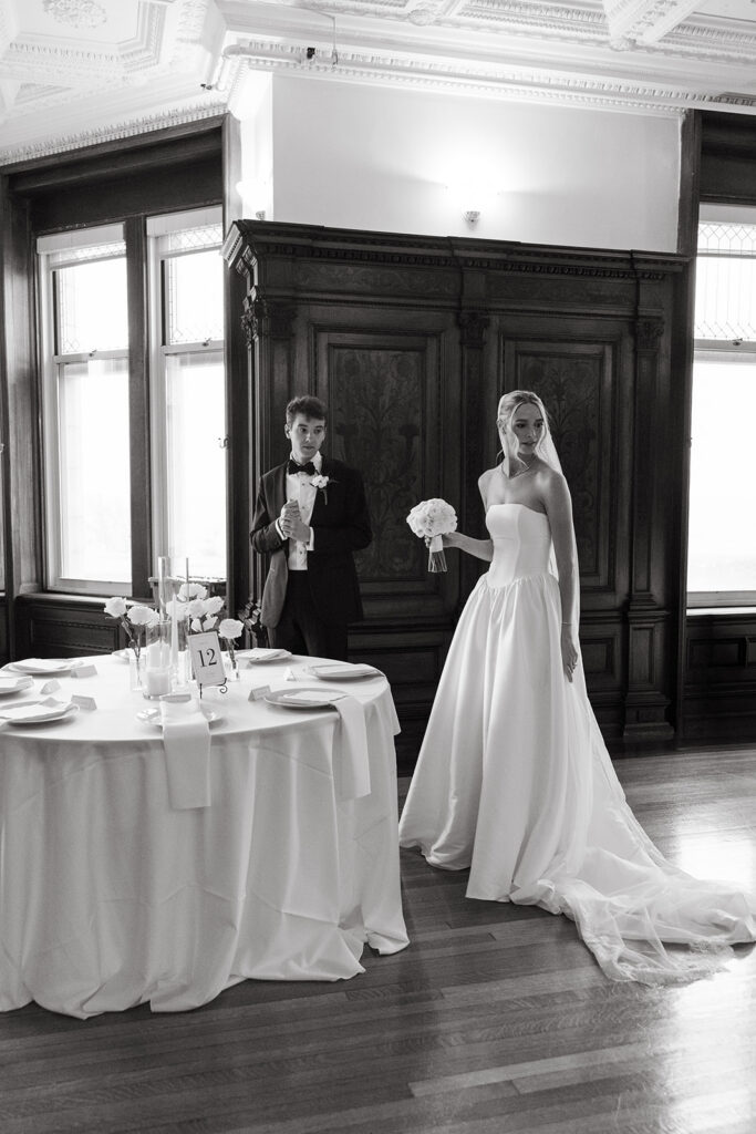 bride and groom walking through their reception space before their guests arrive